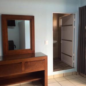 a bathroom with a mirror and a dresser with a mirror at Casa LEONOR in Oaxaca City