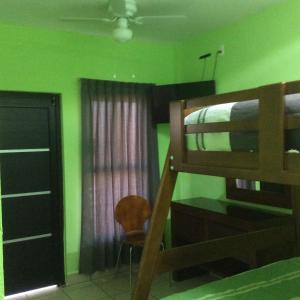 a bedroom with a bunk bed and a chair at Casa LEONOR in Oaxaca City