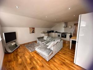 a living room with a couch and a kitchen at Joe Kelly Buildings C in Withernsea