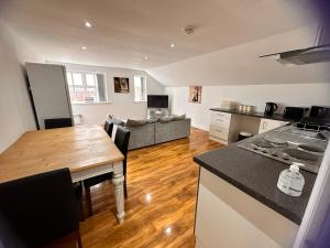 a kitchen and living room with a table and a couch at Joe Kelly Buildings C in Withernsea