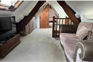 a living room with a couch and a tv at Sleepy Hollow in Taunton