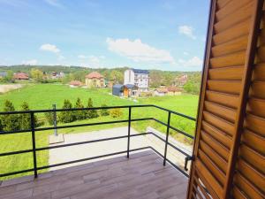a balcony with a view of a green field at Apartman MatiNik in Mionica