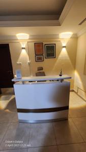 a reception desk in a room with lights at Pharaohs Inn Deira Hostel in Dubai