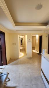 an empty room with a hallway in a building at Pharaohs Inn Deira Hostel in Dubai