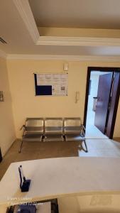a waiting room with two benches and a sign on the wall at Pharaohs Inn Deira Hostel in Dubai