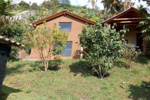 a house with two trees in front of it at La casa de chocolate 1 in Bogotá