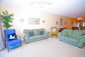 a living room with two couches and a table at Sea Bright 205 condo in Ocean City