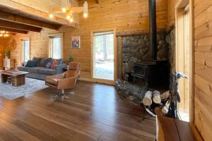 a living room with a couch and a fireplace at Cascade Cabin in Sunriver