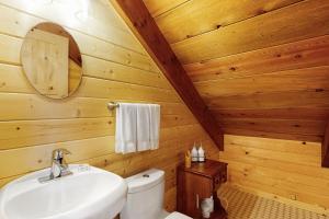 a bathroom with a white sink and a toilet at Cascade Cabin in Sunriver +20 photos