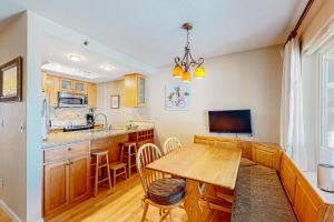 a kitchen and dining room with a wooden table at Vista Del Lago in Stateline