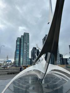 a metal sculpture in a city with tall buildings at Reykjavikrental in Reykjavík