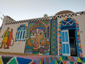 um mural de uma mulher no lado de um edifício em البيت النوبي em Naj‘ al Maḩaţţah