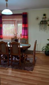 a dining room with a wooden table and chairs at Serbian home Smederevo in Smederevo