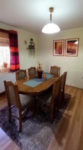 a dining room with a wooden table and chairs at Serbian home Smederevo in Smederevo