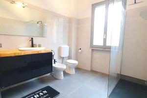 a bathroom with a toilet and a sink and a shower at Casa Gernetto in Lesmo