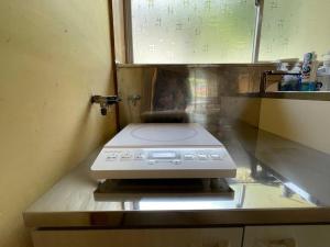 a microwave sitting on top of a kitchen counter at Green Hills in Itoigawa +36 photos