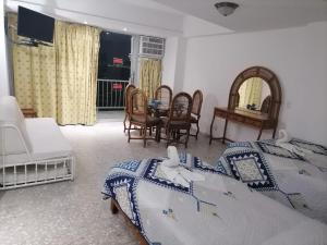 Una cama o camas en una habitación de Suites a pie de playa