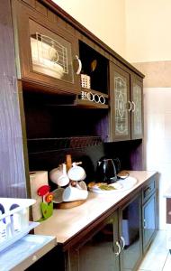 a kitchen with a counter top with a microwave at Homestay D Razak Wakaf Tapai in Marang