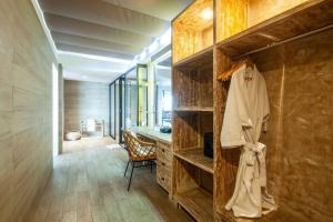 a room with a closet with a desk in it at Cliff front luxury Olala Nusadua Beach in Nusa Dua