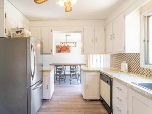 a kitchen with white cabinets and a table with chairs at Cozy Private Home single rooms in Halifax