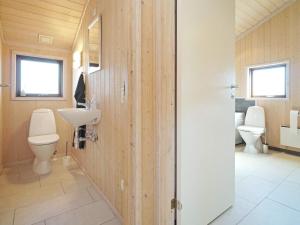 a bathroom with two toilets and a sink and a sink at Holiday home Store Fuglede XXVI in Store Fuglede