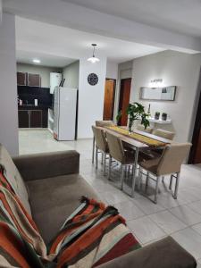 a living room with a couch and a table with chairs at Departamento Capital II in La Rioja