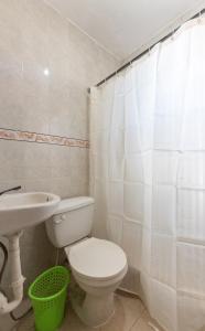 a bathroom with a toilet and a sink at Como en Casa in Mandinga