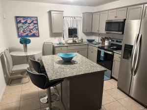 una cucina con un'isola con una ciotola blu sopra di 2/1 Naples Hideaway a Naples