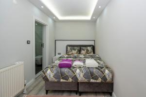 a bedroom with a king sized bed with purple pillows at BOSPHORUS EXCLUSİVE RESİDENCE in Istanbul