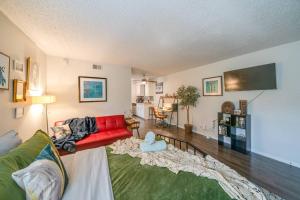 a living room with a red couch and a rug at The Joplin House - Austin - Zilker Park Studio in Austin