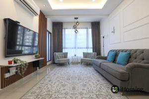 a living room with a couch and a flat screen tv at Bali Residence Malacca Premium By I Housing in Malacca