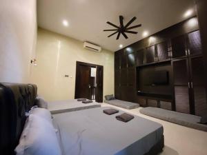 a bedroom with a large bed and a tv at C02 EuroStyle Seri Alam Homestay in Masai