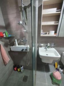 a small bathroom with a sink and a shower at Sea and Noeul Healing House in Seogwipo