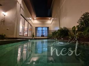 a swimming pool in the middle of a building at The Nest at Luana in Porac