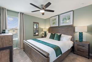 a bedroom with a bed and a ceiling fan at Sea Shore at Solara Resort by Shine Villas #401 villa in Orlando