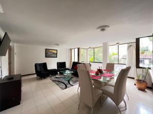 a living room with a table and chairs at Lovely apartment in the best zone of Medellin in Medellín