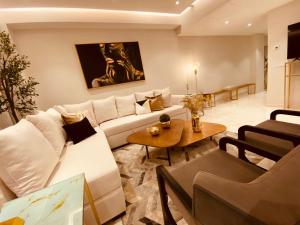 a living room with a white couch and a table at Luxury 2 bedrooms Bolongo Punta Mita in Higuera Blanca