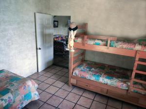a room with two bunk beds and a mirror at Amankaya Atitlan in Cerro de Oro