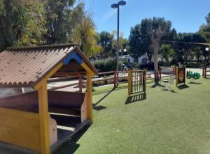 a park with a playground with a wooden fence at Casa Del Parco in Polignano a Mare
