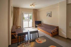 a living room with a couch and a television at Indigo luxury apartments in Olympic Beach