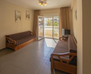 a living room with a couch and a tv at Indigo luxury apartments in Olympic Beach