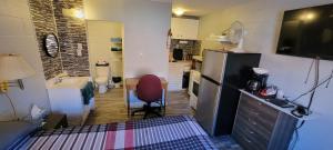 a small kitchen with a sink and a refrigerator at Southview Motel in Westlock
