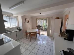 a kitchen with a table and a dining room at 3 Bedroom Town house near Gosford CBD Sleeps 6 plus in Gosford