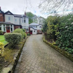 a cobblestone street in a residential neighborhood with houses at ChurstonBnB, private flat within family home, Bolton in Lostock