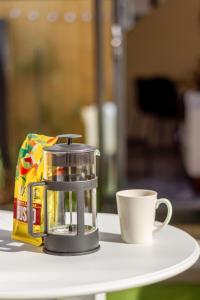 a coffee maker and a cup on a table at The City's Best Kept Secret 2 bed 2 bath in Christchurch