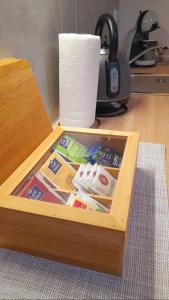 a wooden box on a desk with a roll of toilet paper at Apartman Diana,free parking in Pula