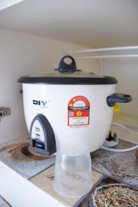 a slow cooker sitting on top of a counter at Just Stay Inn Guest House in Melaka
