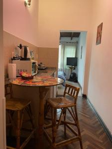 a kitchen with a table and stools in a kitchen at Apartment Salta 2 pax in Salta