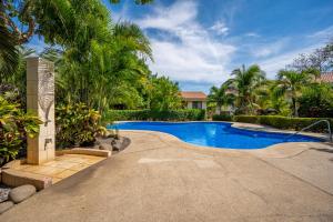 a swimming pool in a yard with palm trees at Dolce Vita 7025 in Coco