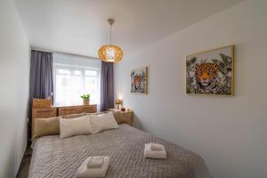 a bedroom with a bed with two towels on it at Apartments24 Laada 4 in Rakvere